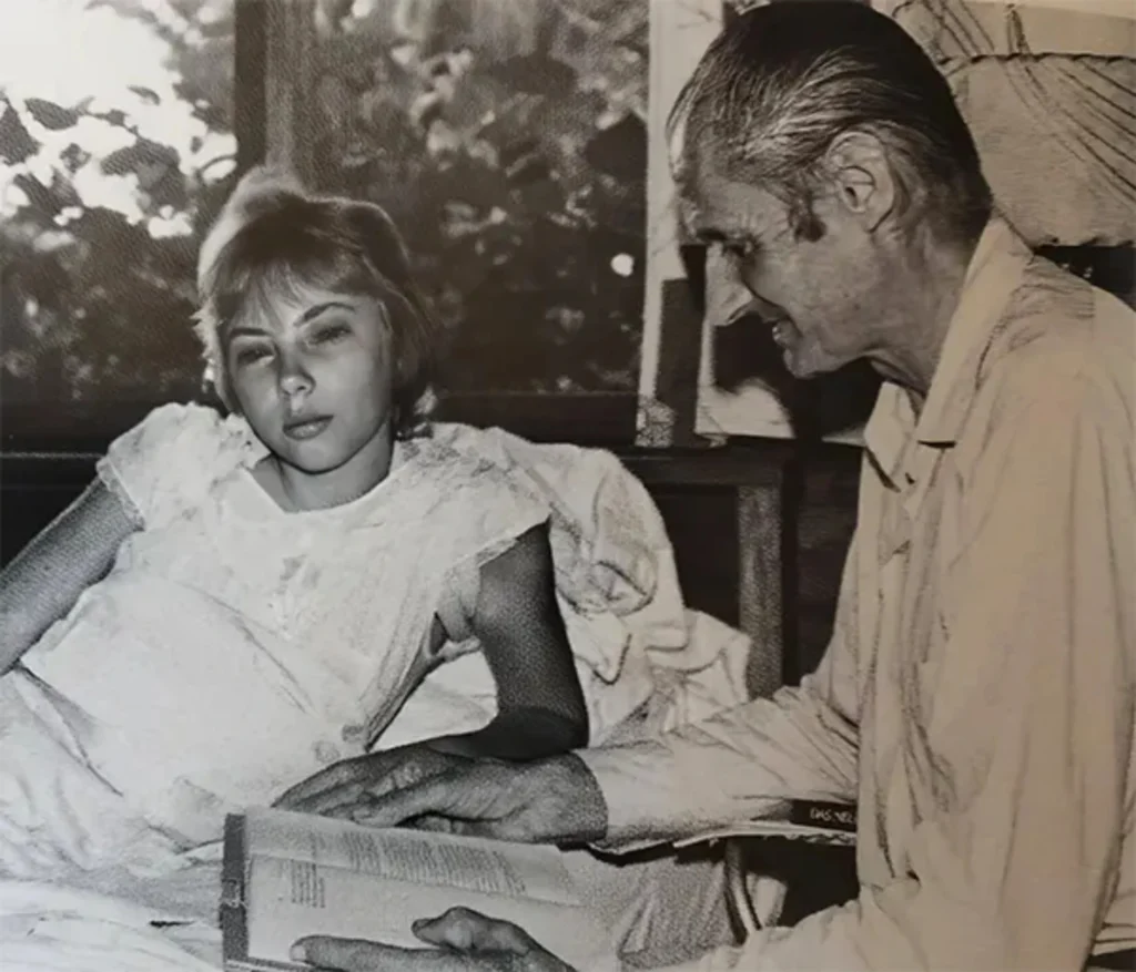 Juliane rests in a Peru hospital with her father after surviving 11 days in the Amazon