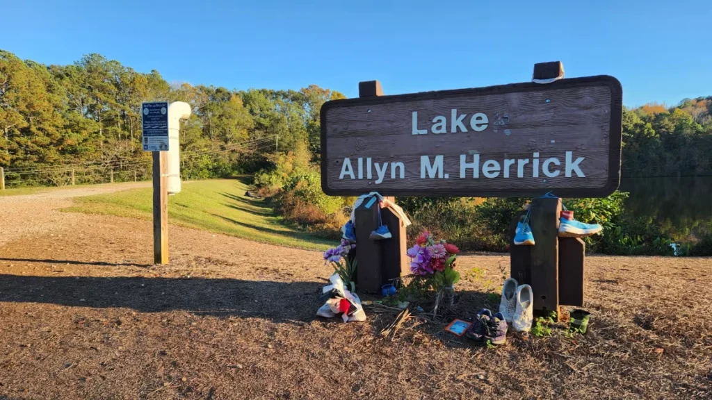 A memorial honors Laken Riley at the entrance to the woods where she was killed.